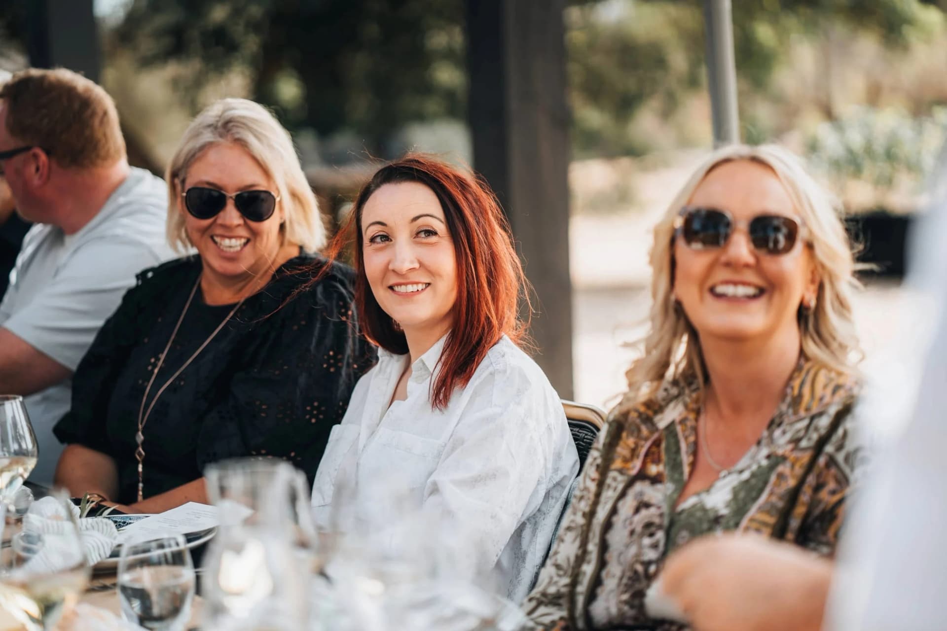 Guests along a single long table at a Sew & Sew lunch