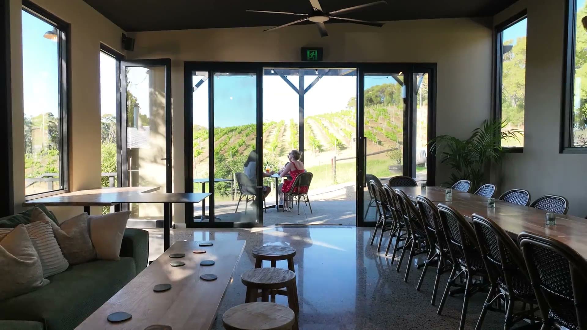 Drone footage flying out of the event space, over the terrace and down the vineyard towards the brewery